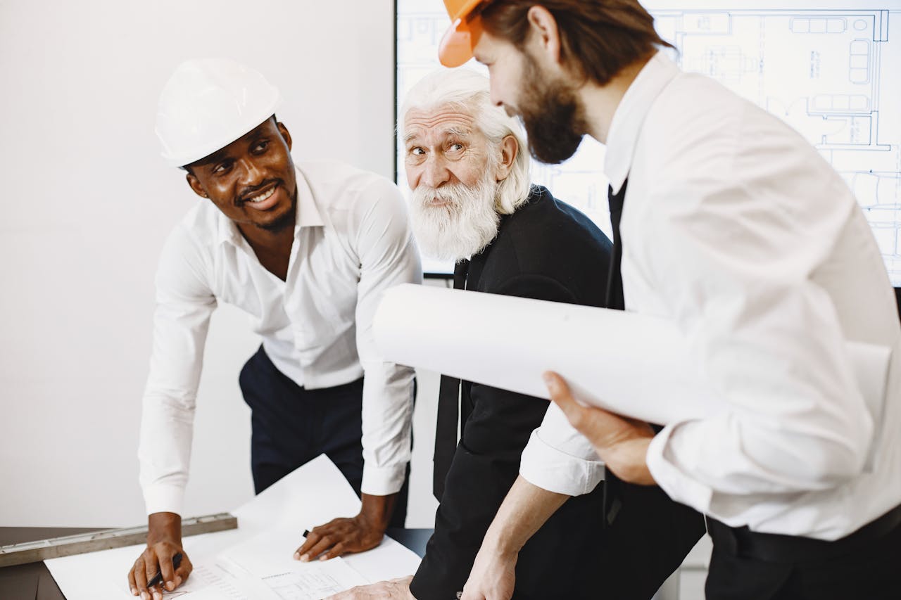 about-01 Engineers and architects working together on a construction plan, demonstrating teamwork and professionalism.